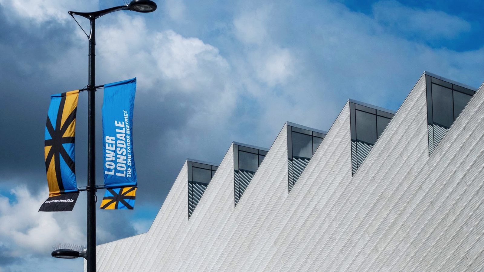 Promotional flags flying in front of the Polygon Gallery.